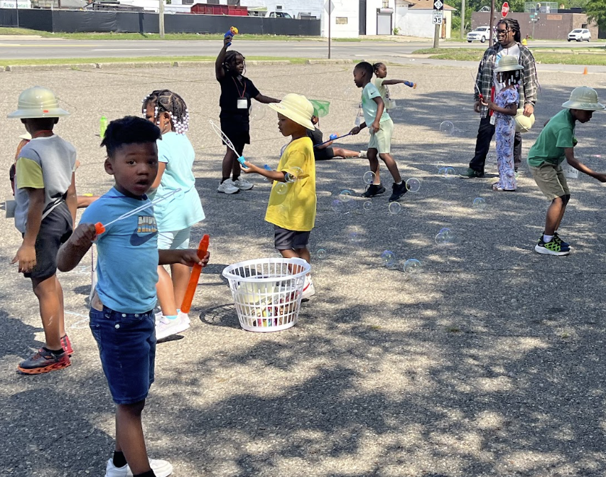 Kids playing with bubbles at an outdoor giveaway