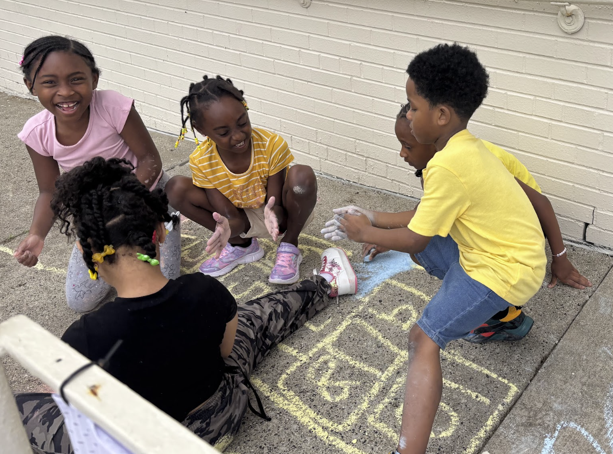 Kids playing hopscotch at a community day