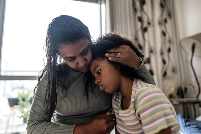 Parent holding a child close at home