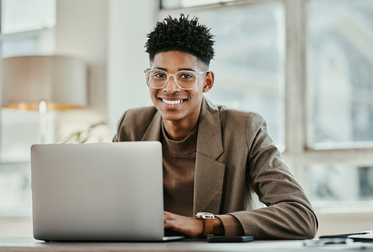 Smiling young professional working on a laptop