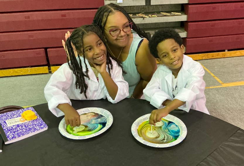 Campers in lab coats doing a science activity