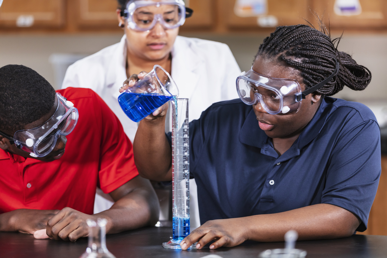 Students measuring a chemistry experiment during an after-school STEM session